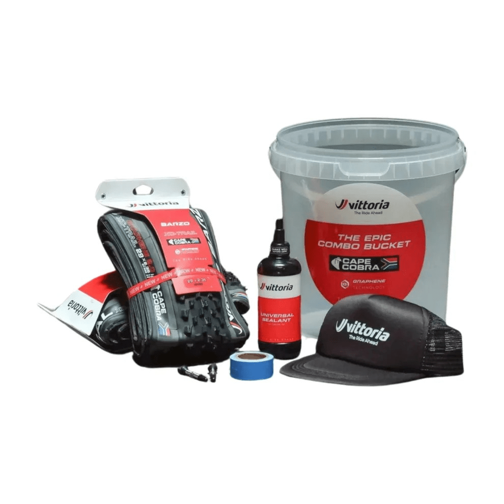 Vittoria cycling products including tires, a bucket, and a cap on a white background